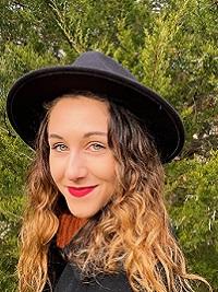 headshot of student grace acquilano english peer advisors, girl with long hair wearing a black hat.