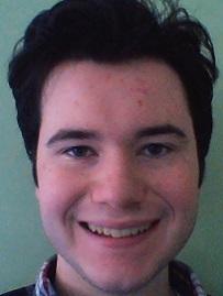 headshot of student with dark hair smiling, english peer advisor