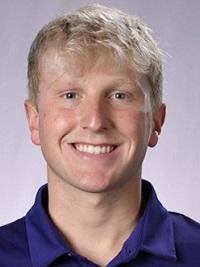 blond hair young man wearing a purple Holy Cross athletic polo with light purple background