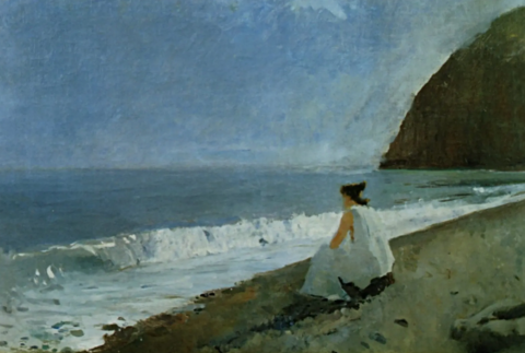 A lone woman dressed in white sits on a rocky coast, arms resting on her thighs, looking out to sea.