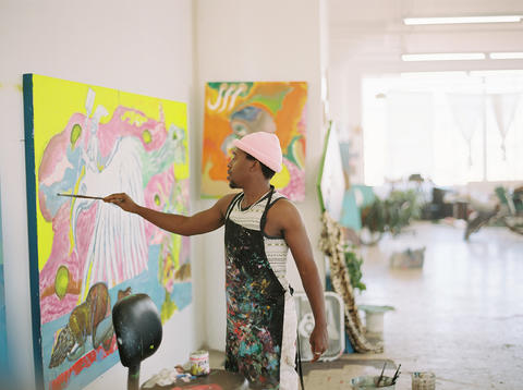  Artist Simphiwe Ndzube working on a painting in the studio.