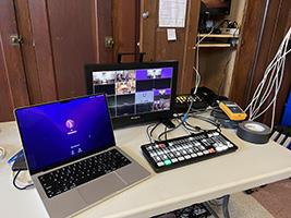 laptop and equipment set up to live stream event