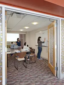 Students working at whiteboard in Figge Hall community room