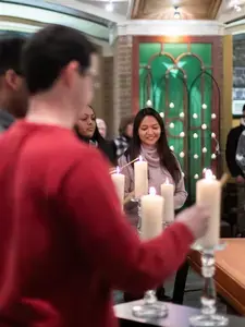 students lighting candles at the multifaith prayer service