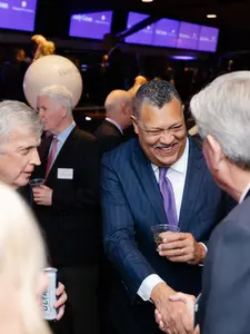 President Rougeau shakes hands at a President's Council event.
