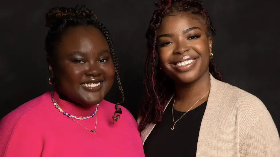 Two women smile for a portrait