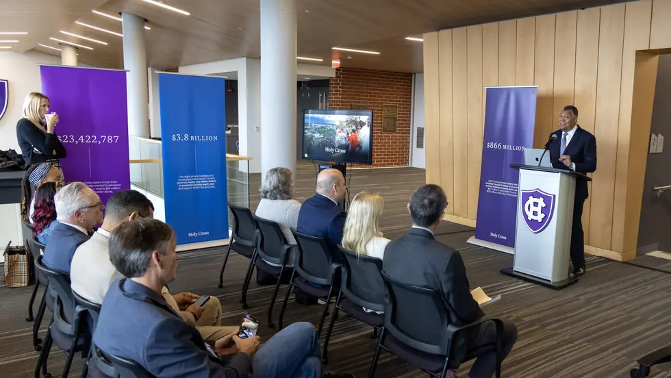 man at podium addresses crowd