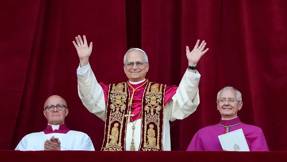 Pope waves at crowd from balcony