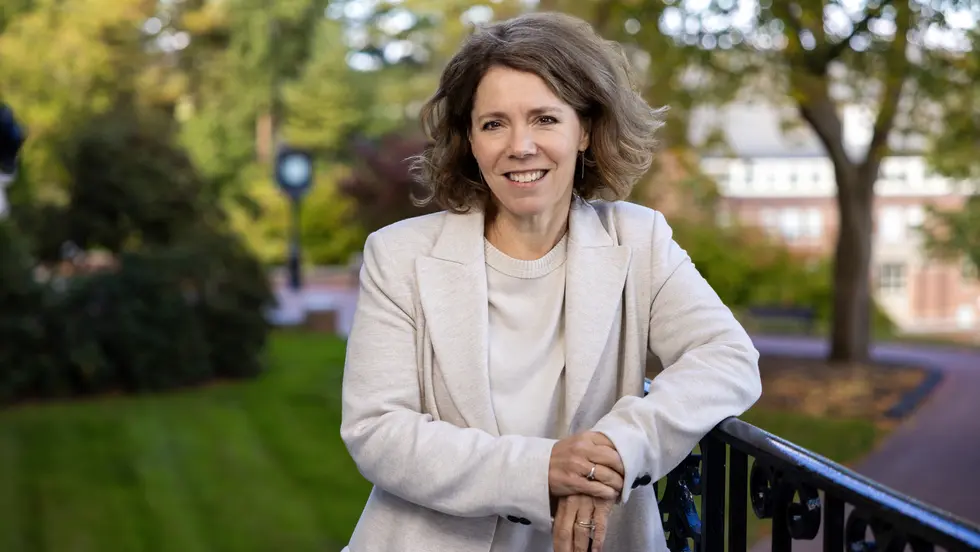 Woman leaning against wrought-iron railing