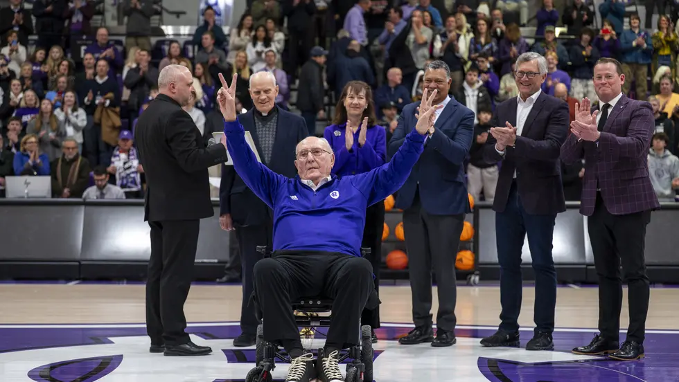 man in wheelchair waves at crowd