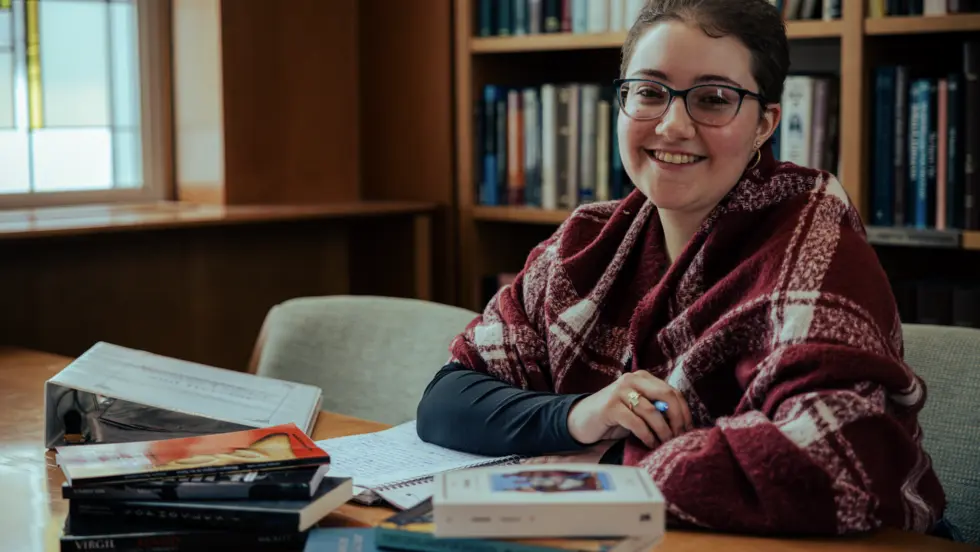 Student at desk with books