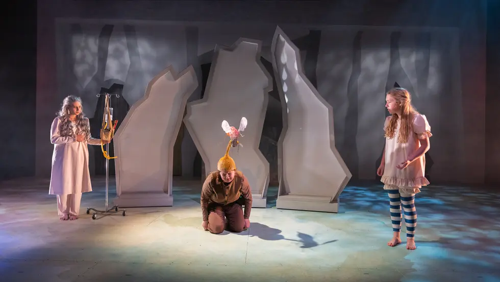 Three students on a stage
