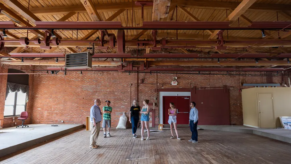 People standing in an old mill building