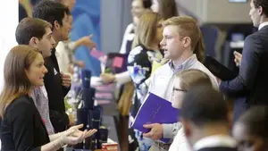 people at a conference talking across a table