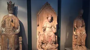 three religious statues on display in a museum