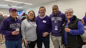 a group of 5 alumni wearing purple 