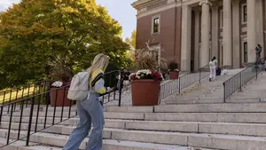 Student walks up stairs on campus