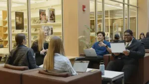 Students discuss a project around a table