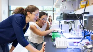 Two science research students examine extremophiles in a summer lab at Holy Cross