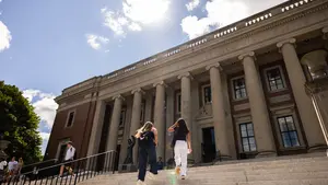 Students climbing steps on a sunny day