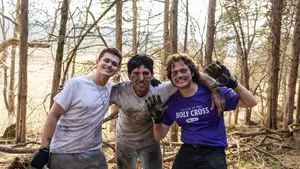 Three students pose for a photo doing outdoor work in Virginia
